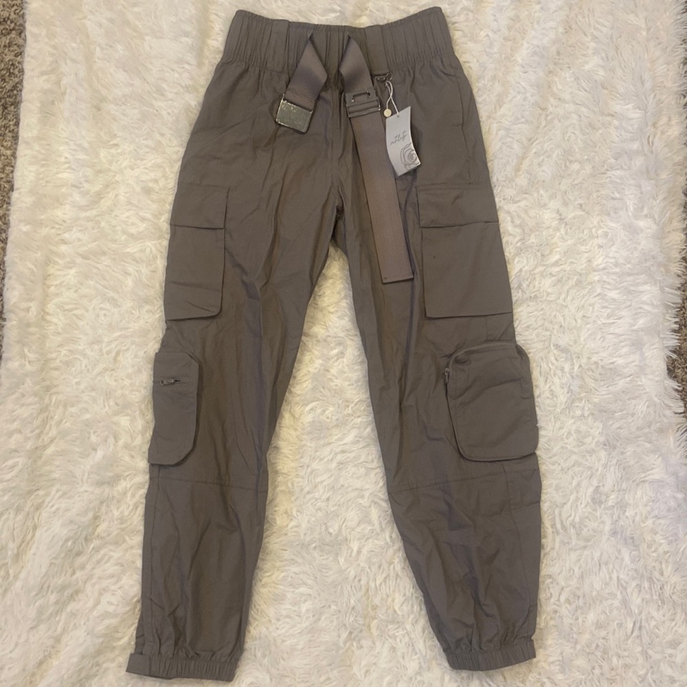 Vitality cargo joggers. High waisted with clasp buckle. Velcro and zip pockets.